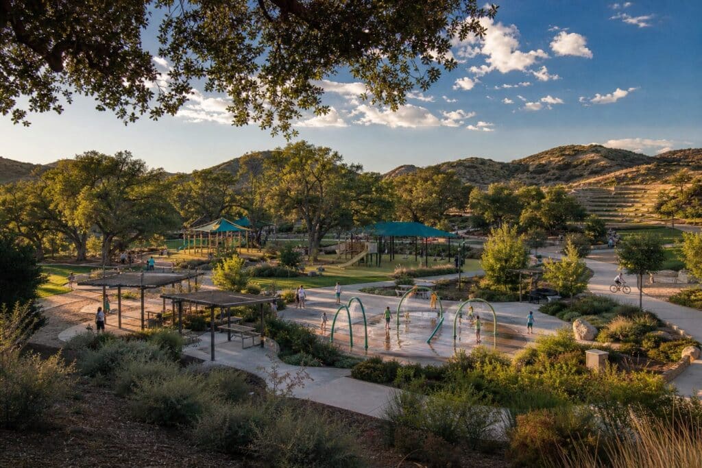 Families enjoy a sunny afternoon at a sprawling 50-acre community park with playgrounds and trails adjacent to Avila in Porter Ranch.