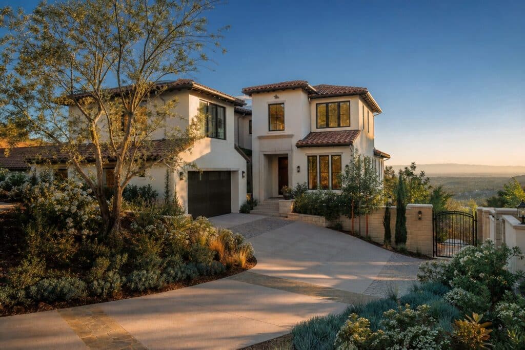 Contemporary stucco home in foothill Porter Ranch with valley views, native landscaping, and elevated terrain typical of Avila.
