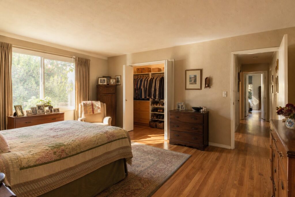 Sunlit bedroom inside a Granada Hills family home showing personal belongings and mid-century architectural details.