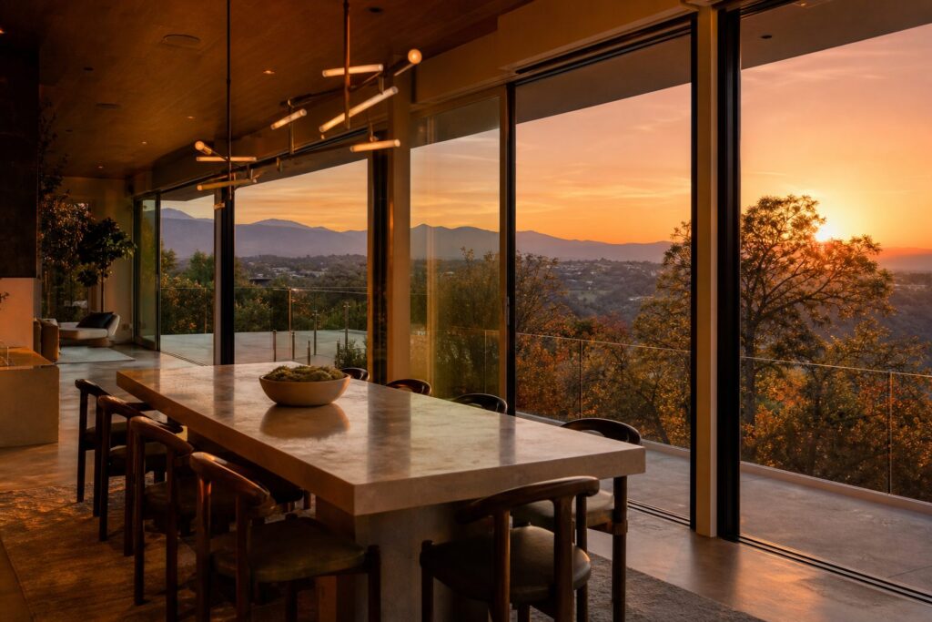 Hillcrest dining room with valley views at golden hour, showcasing the elevated lifestyle and mountain scenery of Porter Ranch.