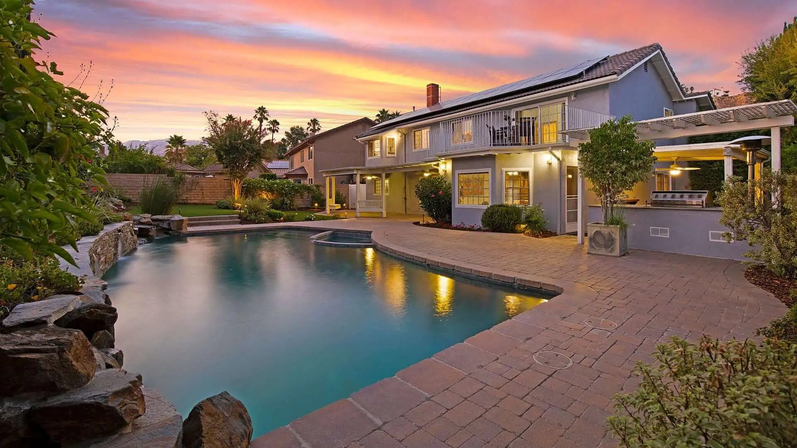 A San Fernando Valley pool home at dusk, listed by Scott Himelstein